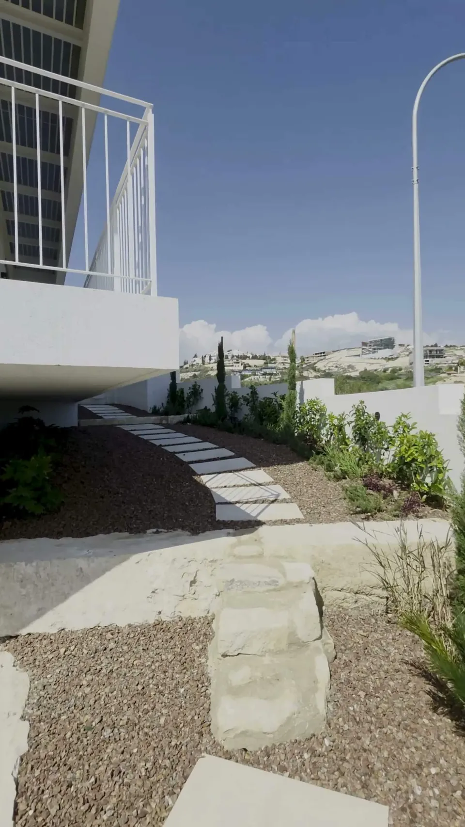 Walk through the finished details.
Soft light on white walls. Stepping stones through quiet planting. Shaded terraces th